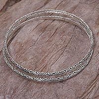 Sterling silver bangle bracelets, 'Indonesian Moon' (pair) - Two 925 Sterling Silver Handmade Engraved Bangles from Bali