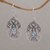 Blue topaz dangle earrings, 'Daylight Lotus' - Blue Topaz and Sterling Silver Lotus Dangle Earrings thumbail