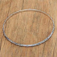 Sterling silver bangle bracelet, 'Puppy World' - Sterling Silver Bangle Bracelet with Paw Print Motifs