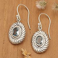 Blue topaz dangle earrings, 'Spiral Water' - Oval Spiral Faceted Two-Carat Blue Topaz Dangle Earrings