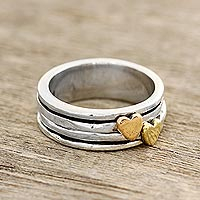 Sterling silver spinner ring, 'Traveling Hearts' - Heart Motif Sterling Silver and Brass Spinner Ring
