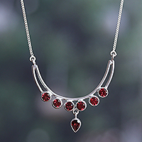 Garnet pendant necklace, 'Passionate Crescent' - Polished Sterling Silver and Natural Garnet Pendant Necklace