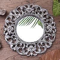 Wood wall mirror, 'Black Balsamina Buds' - Hand Carved Black Floral 15-Inch Wall Mirror from Bali
