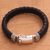 Men's leather braided wristband bracelet, 'Jagaraga Swirl' - Men's Sterling Silver and Braided Black Leather Bracelet thumbail
