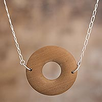 Wood pendant necklace, 'Nature Circle' - Pumaquiro Wood and 925 Sterling Silver Pendant Necklace