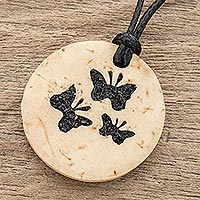 Coconut shell and lava stone pendant necklace, 'Three Butterflies' - Coconut Shell and Lava Stone Butterfly Pendant Necklace