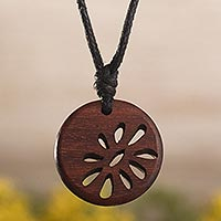 Wood pendant necklace, 'Balsam Flower' - Wooden Disk with Abstract Flower Design on Cotton Cord
