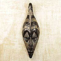 African wood mask, 'Back to My Roots' - Hand Carved Black Sese Wood Wall Mask with Bird from Ghana