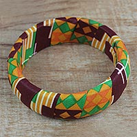 Wood and cotton bangle bracelet, 'Cheerful Sunrise' - Wrapped Cotton Print Bangle Bracelet in Green and Orange
