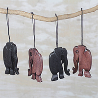 Ebony wood ornaments, 'Jungle Jaunt' (set of 4) - Handcrafted Ebony Wood Walking Elephant Ornaments (Set of 4)