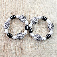 Recycled glass and plastic beaded stretch bracelets, 'Alewa' (pair) - Black and White Recycled Beaded Stretch Bracelets (Pair)