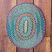 Raffia wall art, 'Queen's Happiness I' - Handwoven Oval Cerise and Teal Raffia Wall Art from Ghana