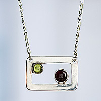 Peridot and garnet pendant necklace, 'Adrift' - Modern Peridot and Garnet Necklace in Sterling Silver