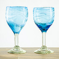 Recycled blown glass wine glasses, 'Aqua Swirls' (pair) - Pair of Hand Blown Wine Glasses Crafted from Recycled Glass