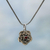 Garnet flower necklace, 'Holy Lotus' - Floral Sterling Silver and Garnet Pendant Necklace