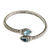 Blue topaz bangle bracelet, 'Tears of Buddha' - Fair Trade Sterling Silver and Blue Topaz Bangle Bracelet thumbail