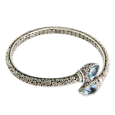Blue topaz bangle bracelet, 'Tears of Buddha' - Fair Trade Sterling Silver and Blue Topaz Bangle Bracelet