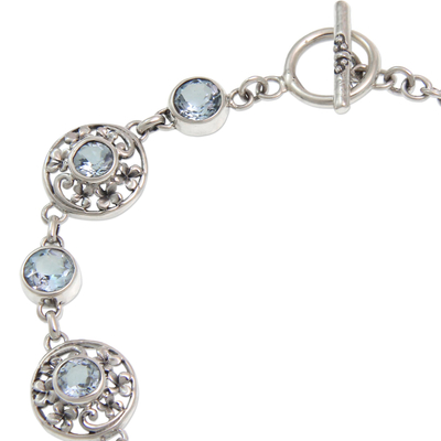 Blue topaz flower bracelet, 'Frangipani Glam' - Floral Sterling Silver and Blue Topaz Link Bracelet