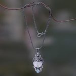 Blue topaz and bone pendant necklace, 'Dayang Sumbi' - Carved Bone and Blue Topaz Silver Pendant Necklace
