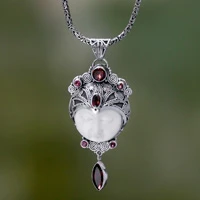 Carved pendant necklace with Garnet, 'Layonsari' - Carved Pendant Necklace with Garnet from Bali