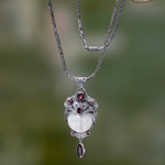 Carved pendant necklace with Garnet, 'Layonsari' - Carved Pendant Necklace with Garnet from Bali