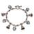 Blue topaz charm bracelet, 'Love's Melody' - Blue Topaz and Sterling Silver Heart and Bell Charm Bracelet