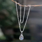 Blue topaz pendant necklace, 'Padma Lotus' - Artisan Crafted Floral Silver Necklace with Blue Topaz