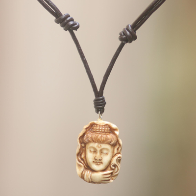 Bone pendant necklace, 'Peaceful Face' - Carved Cow Bone Pendant Necklace Handmade in Bali