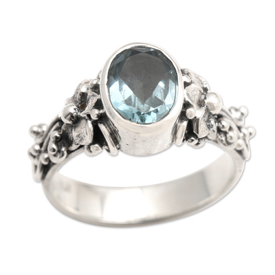 Blue topaz single stone ring, 'Frangipani Path' - Oval Cut Blue Topaz and Silver Ring with Floral Design