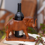 Wood wine bottle holder, 'Sumatran Elephant' - Hand Carved Suar Wood Elephant Wine Bottle Holder