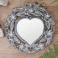 Wall mirror, 'Black Frangipani Heart' - Suar Wood Hand Carved Heart Shaped Floral Wall Mirror