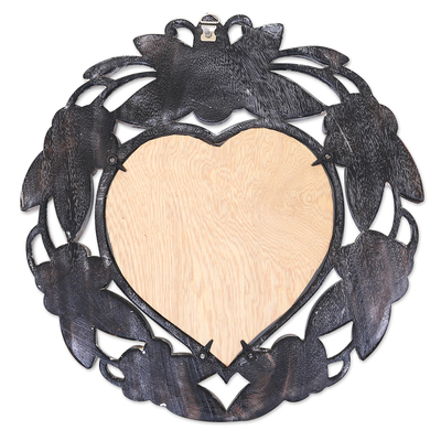 Wandspiegel, 'Black Frangipani Heart' - Handgeschnitzter, herzförmiger, floraler Wandspiegel aus Suar-Holz