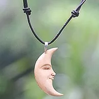 Bone and leather pendant necklace, 'Serene Crescent Moon' - Hand Carved Balinese Moon Necklace in Leather and Bone