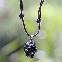 Bone pendant necklace, 'Black Skull' - Carved Bone Skull Pendant on Cord Handmade in Indonesia