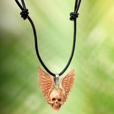 Bone pendant necklace, 'Flying Skull' - Hand Carved Bone Pendant Necklace of a Skull from Indonesia
