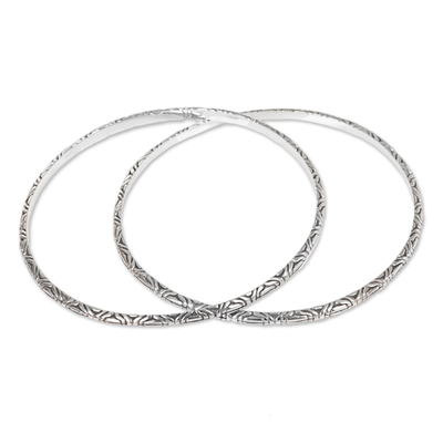 Sterling silver bangle bracelets, 'Indonesian Moon' (pair) - Two 925 Sterling Silver Handmade Engraved Bangles from Bali