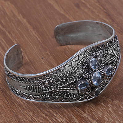 Blue topaz cuff bracelet, 'Directions' - Hand Crafted Sterling Silver and Blue Topaz Cuff Bracelet