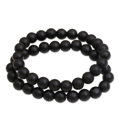 Onyx-Perlenstretcharmbänder, 'Dark Planets' (Paar) - Ein Paar Perlenarmbänder aus schwarzem Onyx aus Bali