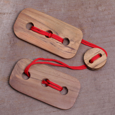 Teak wood puzzle, 'Red Omed-Omedan' - Fair Trade Handmade Teak Wood Pub Style Puzzle