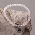 Rose quartz beaded stretch bracelet, 'Still Rose' - Rose Quartz and Flower Charm Beaded Bracelet from Bali