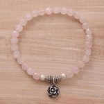 Rose quartz beaded stretch bracelet, 'Still Rose' - Rose Quartz and Flower Charm Beaded Bracelet from Bali