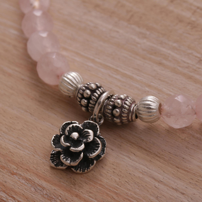 Rose quartz beaded stretch bracelet, 'Still Rose' - Rose Quartz and Flower Charm Beaded Bracelet from Bali