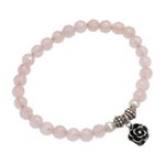 Rose quartz beaded stretch bracelet, 'Still Rose' - Rose Quartz and Flower Charm Beaded Bracelet from Bali