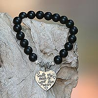 Onyx beaded stretch bracelet, 'Path of Love in Matte' - Black Onyx and Heart Charm Beaded Bracelet from Bali