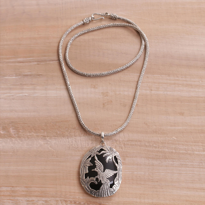 Onyx pendant necklace, 'Cendrawasih Haven' - Onyx and Sterling Silver Bird Pendant Necklace from Bali