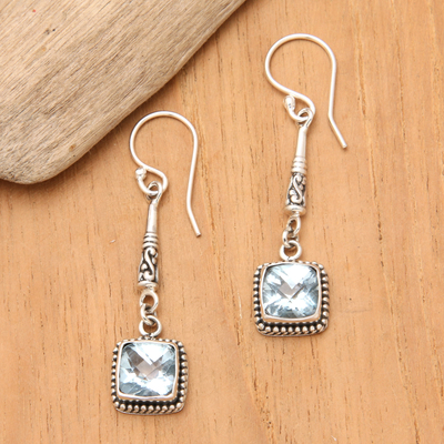 Blue topaz dangle earrings, 'Majestic Gleam' - Faceted Blue Topaz and 925 Silver Dangle Earrings from Bali