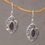 Gold-accented garnet dangle earrings, 'Defiant Beauty' - Gold-accented Garnet Swirl Motif Dangle Earrings from Bali (image 2) thumbail