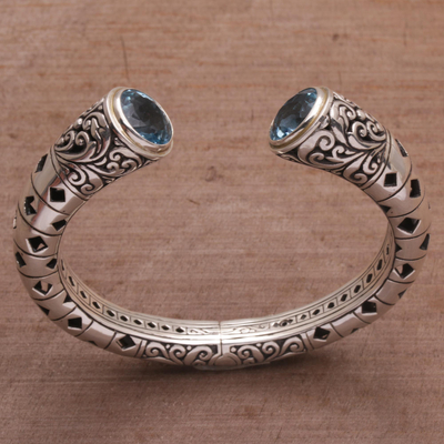 Blue topaz cuff bracelet, 'Borobudur Dew' - Blue Topaz and Sterling Silver Borobudur Motif Cuff Bracelet