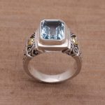 Gold accented blue topaz single stone ring, 'Blue Extravaganza' - Handmade Blue Topaz Single Stone Ring with Gold Accents