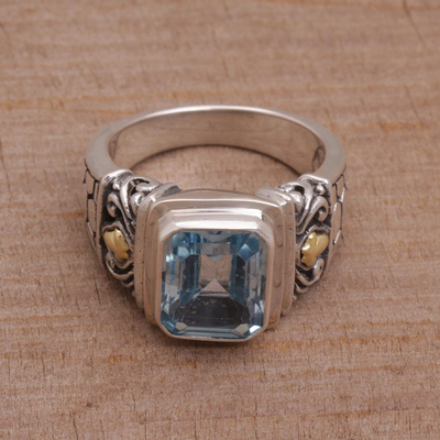Gold accented blue topaz single stone ring, 'Blue Extravaganza' - Handmade Blue Topaz Single Stone Ring with Gold Accents